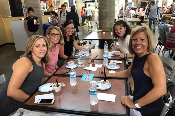 Group of women enjoying samples on a food tour