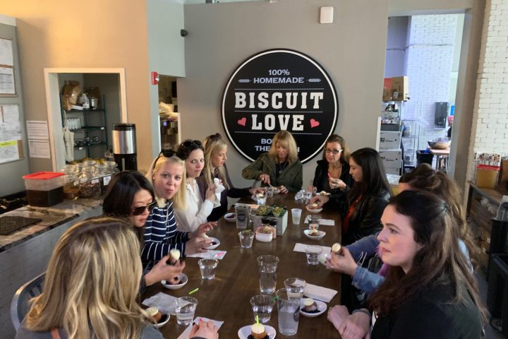 Erin Torpey et al. sitting at a table with wine glasses