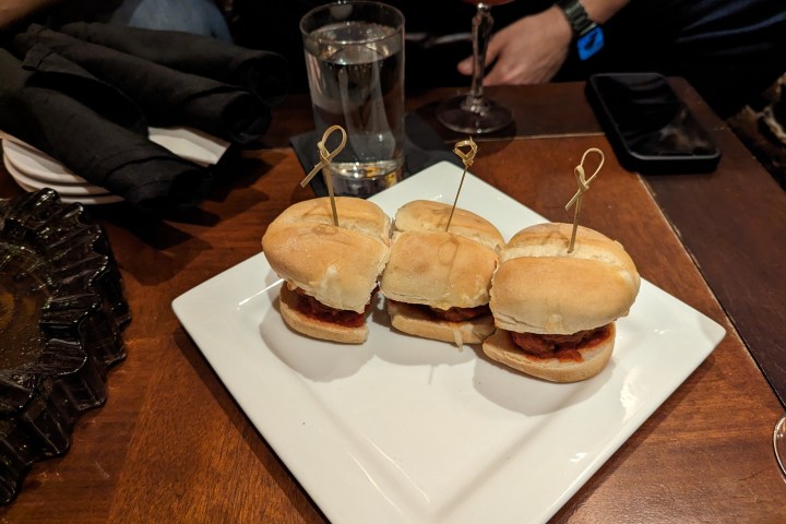 a sandwich sitting on top of a cutting board with a cake
