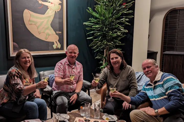 a group of people sitting at a table with wine glasses