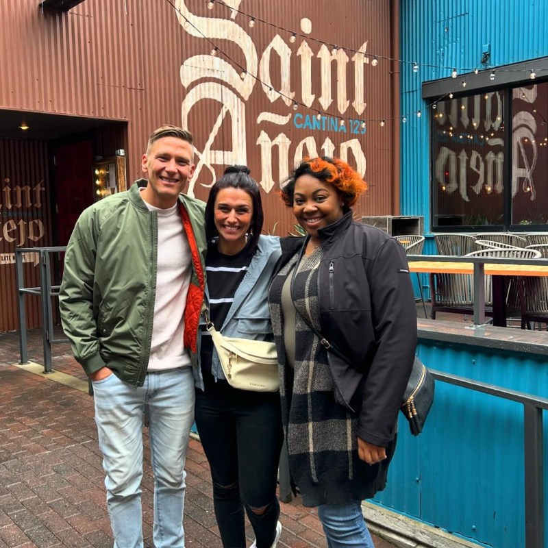 three people smiling at camera