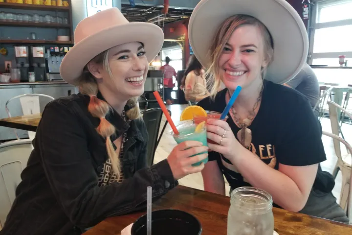 two people smiling with drinks