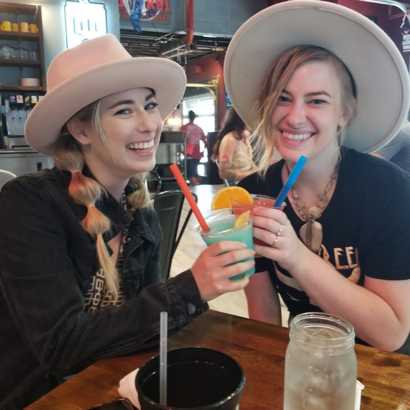 two people smiling with drinks